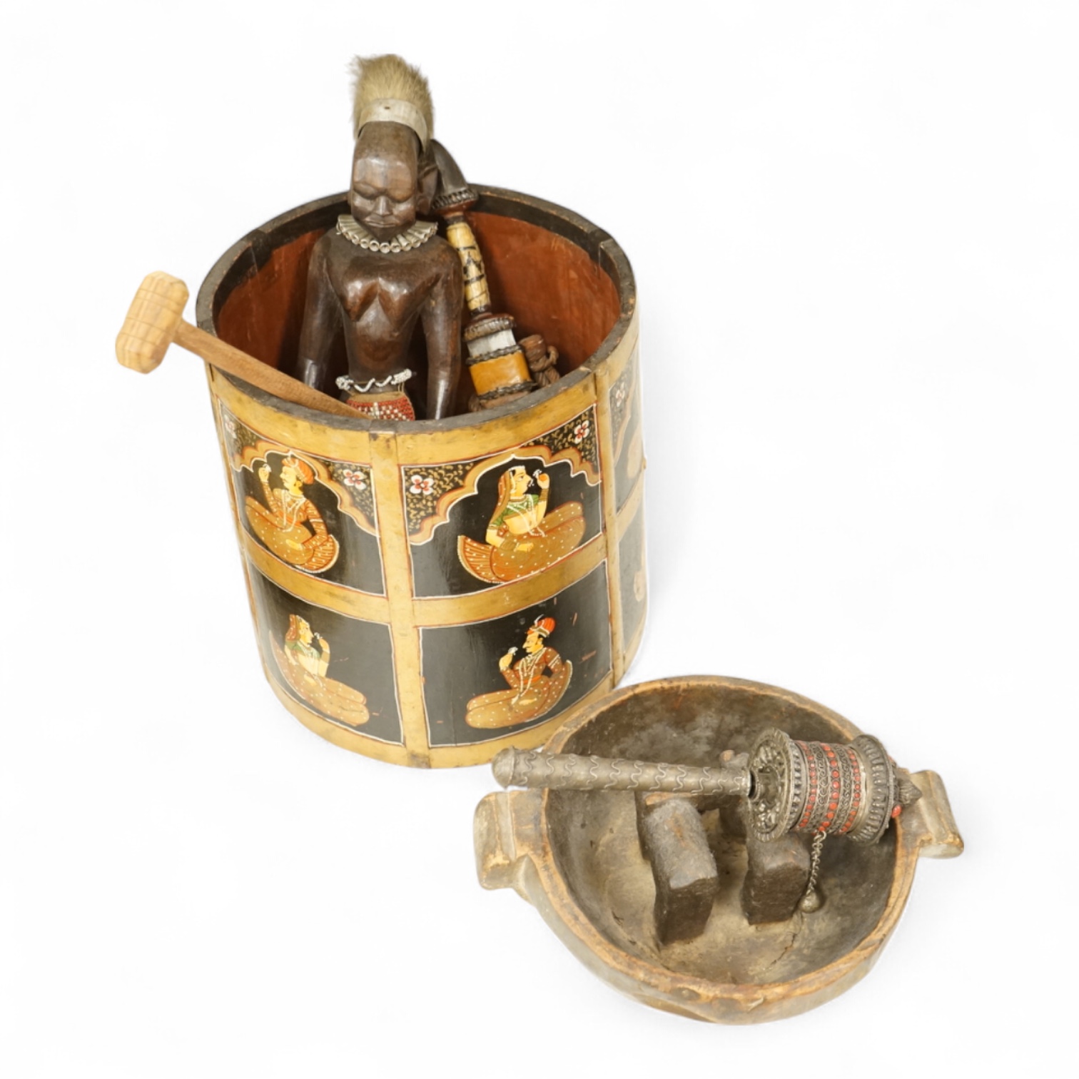 A collection of tribal and Asian collectables including a Tibetan prayer wheel, carvings, etc.